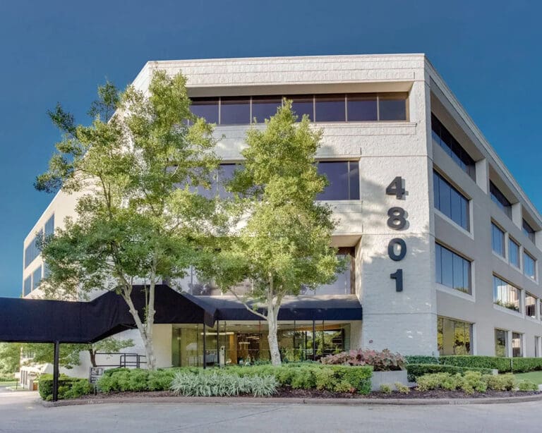 Exterior view of the Podiatry West Oaks office in the Houston area, showing a mid-rise beige medical building, and covered entrance.