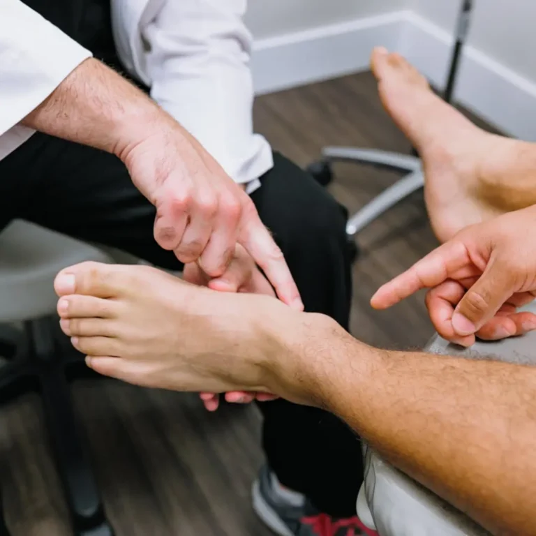 Physician examining a patient's feet.