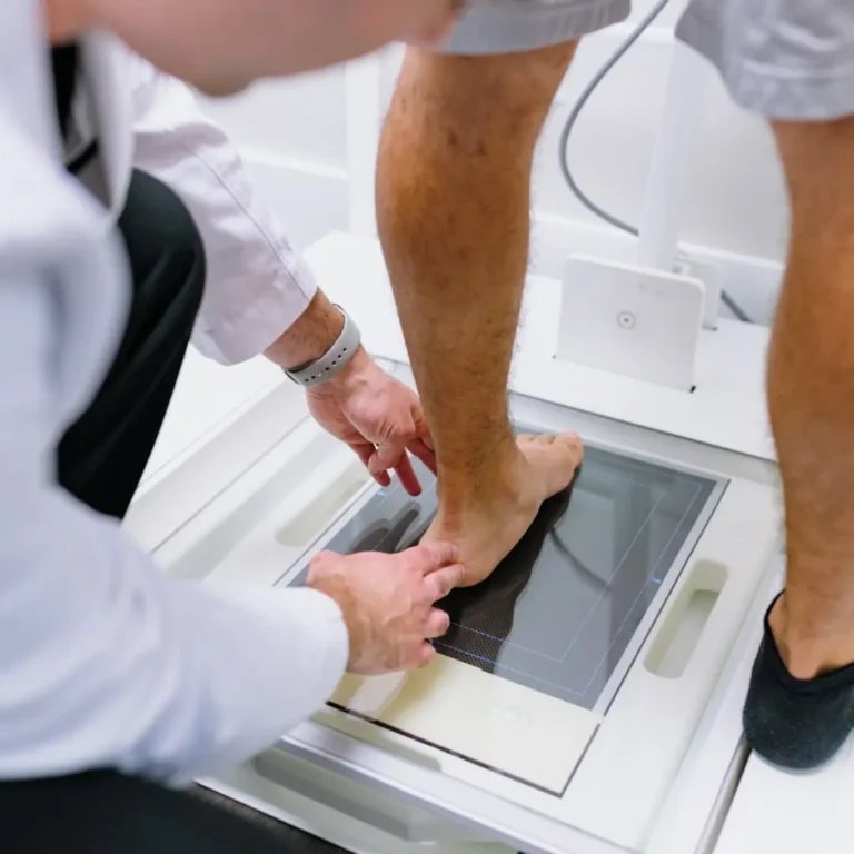 a person standing on a X-ray machine.