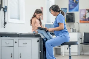 Picture of a podiatrist examining a child.