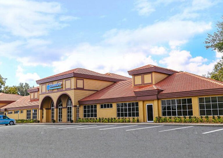 Exterior Photo of medical building, a brick facade with red tile roof, and the Pleasant Hill Kissimmee location for Modern Foot & Ankle