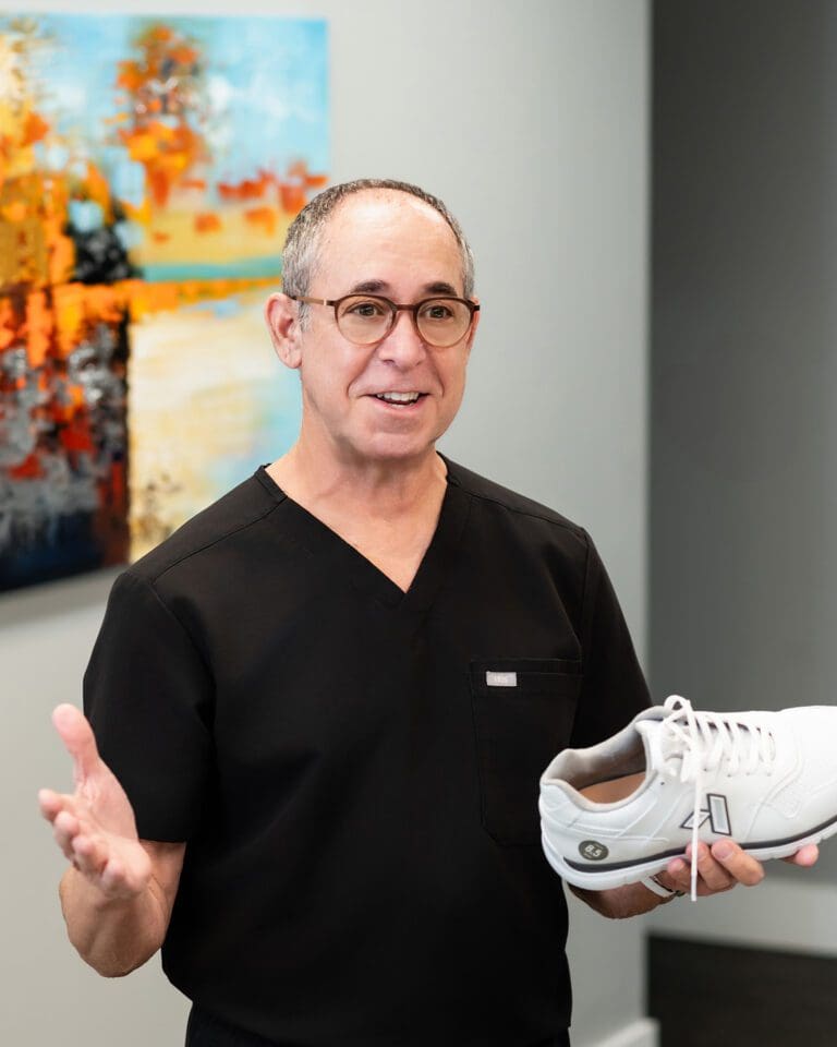 Dr. Stephen Baker, a male podiatrist in Tampa, Florida, explaining supportive footwear in conversation